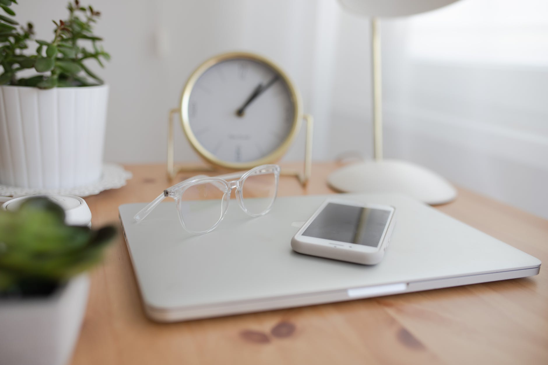 laptop and smartphone on table in room