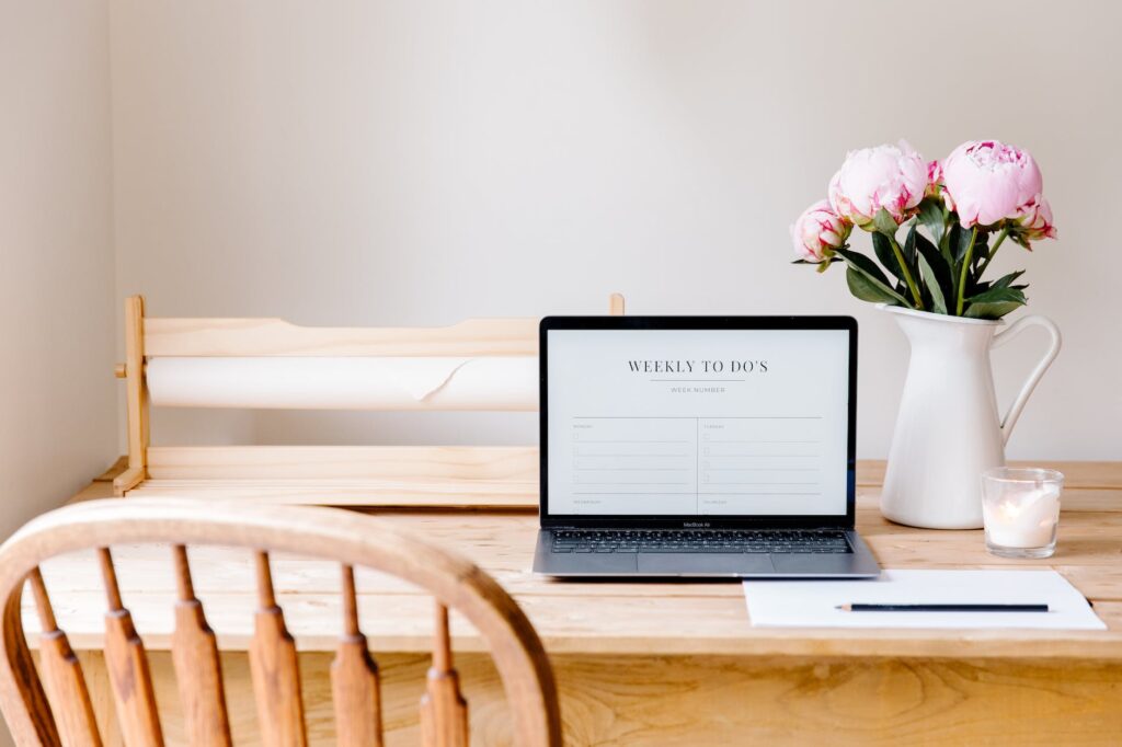 laptop and flowers on table